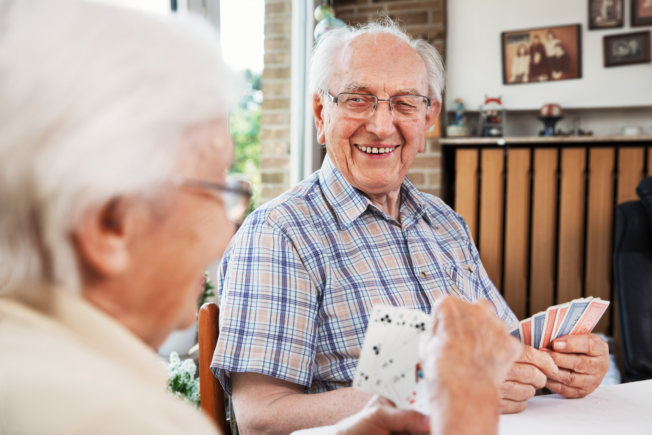 Elderly couple playing cards